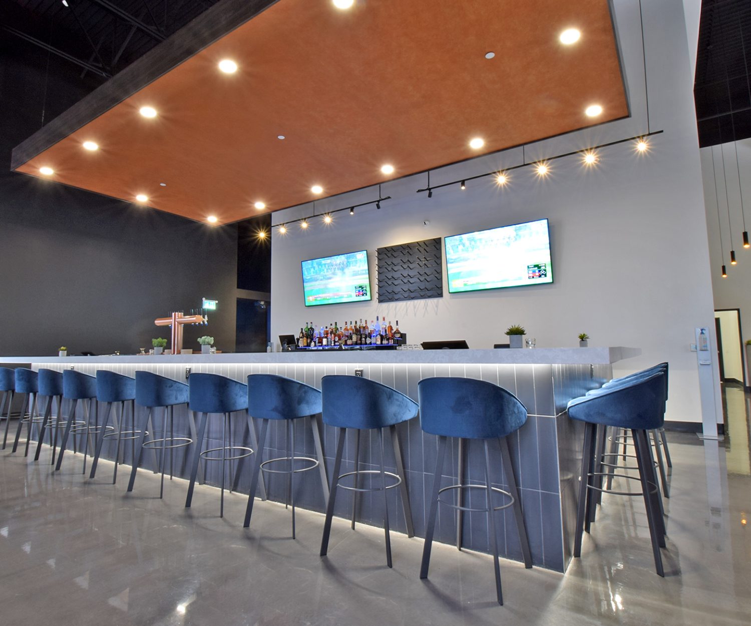 An inviting and stylish restaurant bar in Barrie, Ontario, featuring a sleek and contemporary design, cozy seating, and a well-stocked bar.