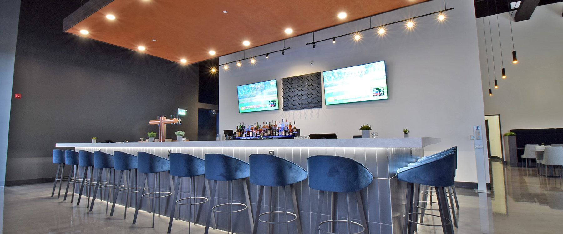 An inviting and stylish restaurant bar in Barrie, Ontario, featuring a sleek and contemporary design, cozy seating, and a well-stocked bar.